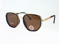 Prada polarized sunglasses with gold frame, brown lenses, and bold style.