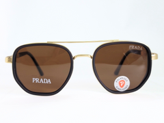 Prada polarized sunglasses with gold frame, brown lenses, and bold style.